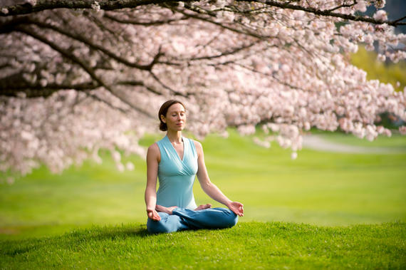 Past Continuous - Woman was sitting in lotus position under cherry tree